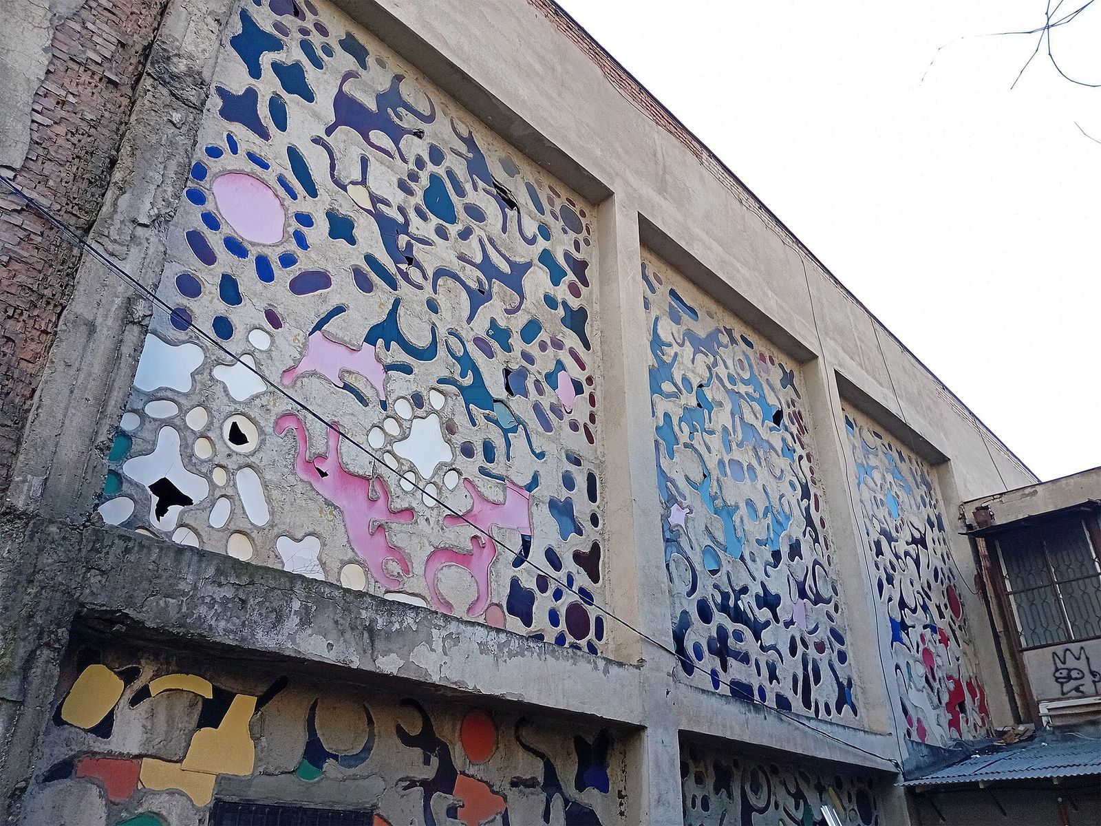 Zurab Tsereteli's glass panels of blue, pink and white shapes set into the concrete walls of the Trade Union Cultural Center in Saburtalo