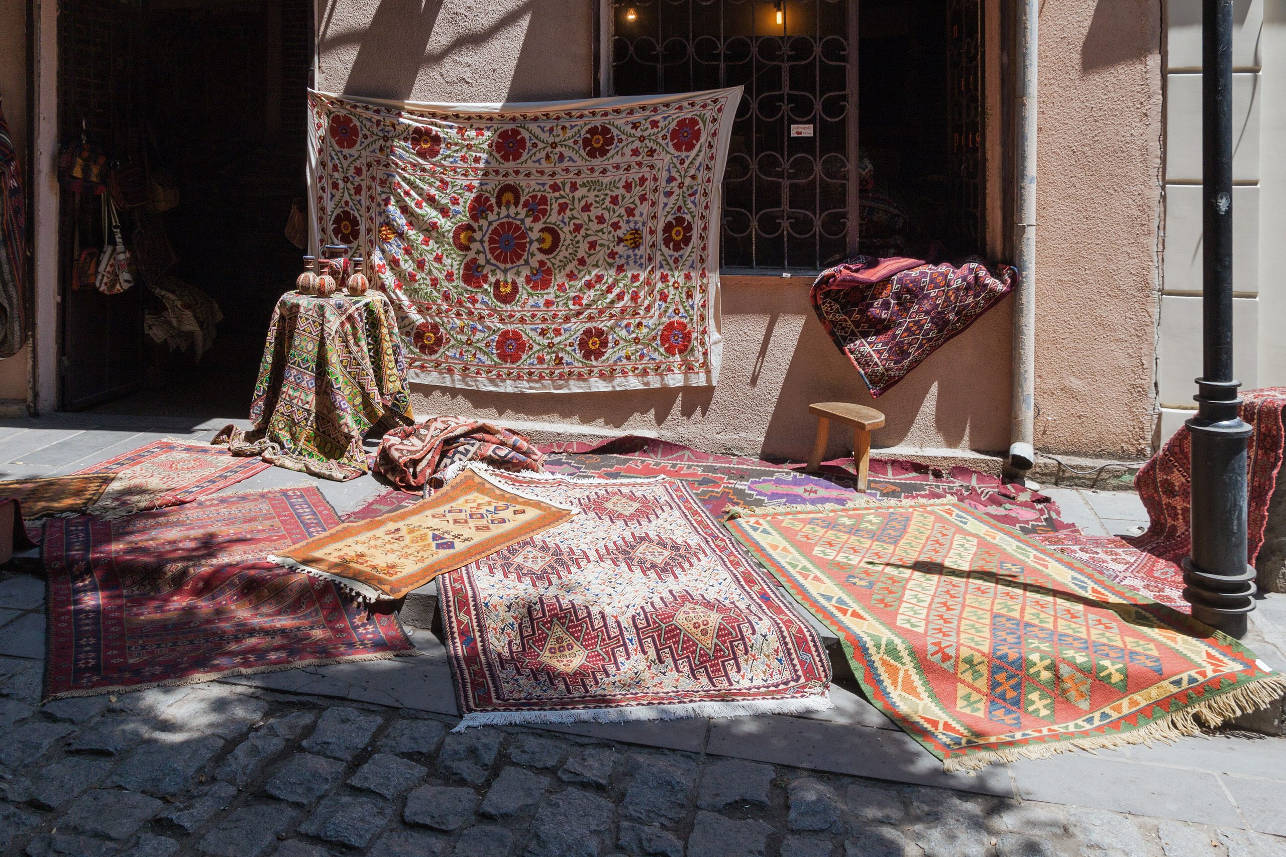 Carpets laid out for sale on a cobbled street in Old Tbilisi