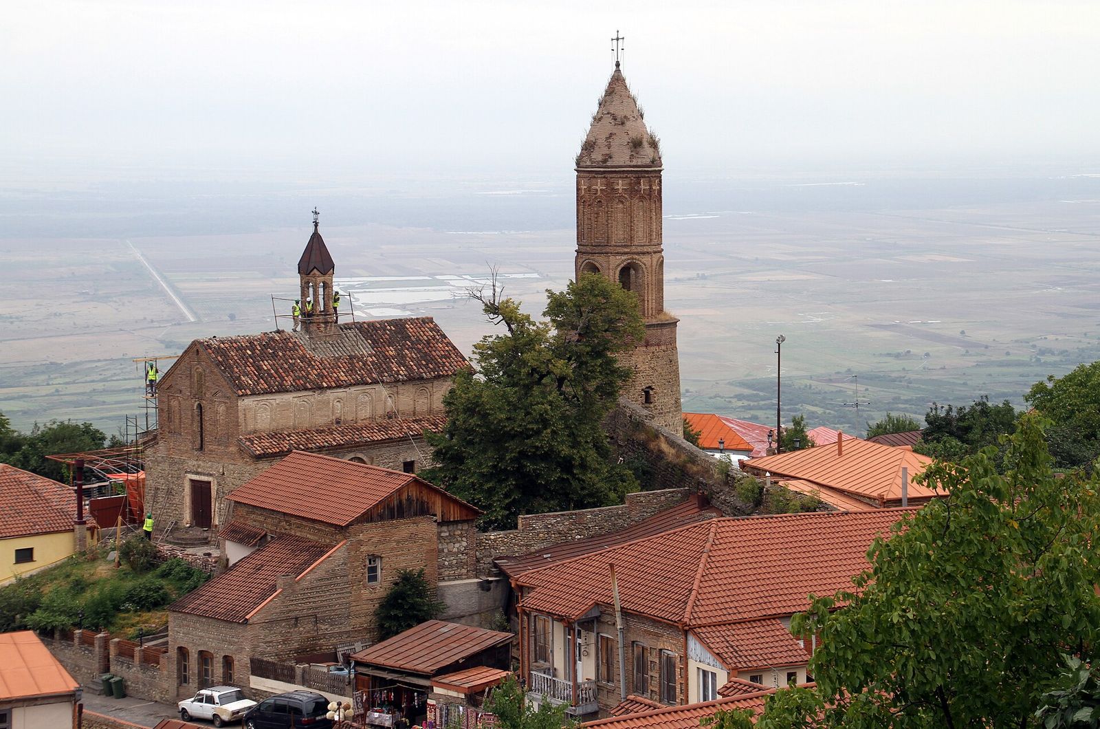 St. George's Church in Sighnaghi with its small belfry and tall brick bell tower above the town wall and the Alazani Valley