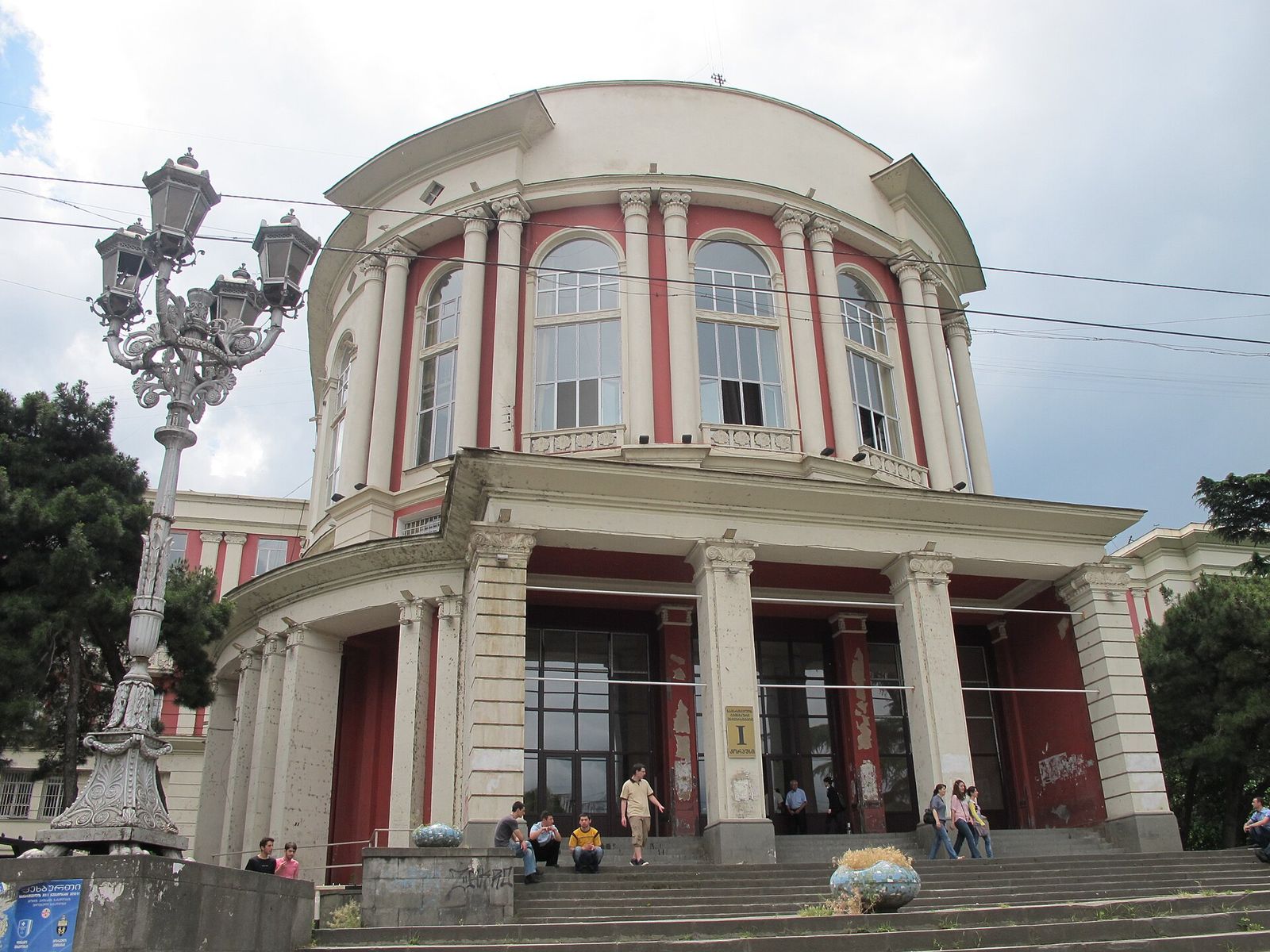 The red-and-white rotunda of Georgian Technical University's Building 1, with tall arched windows, paired columns and a portico over the main steps