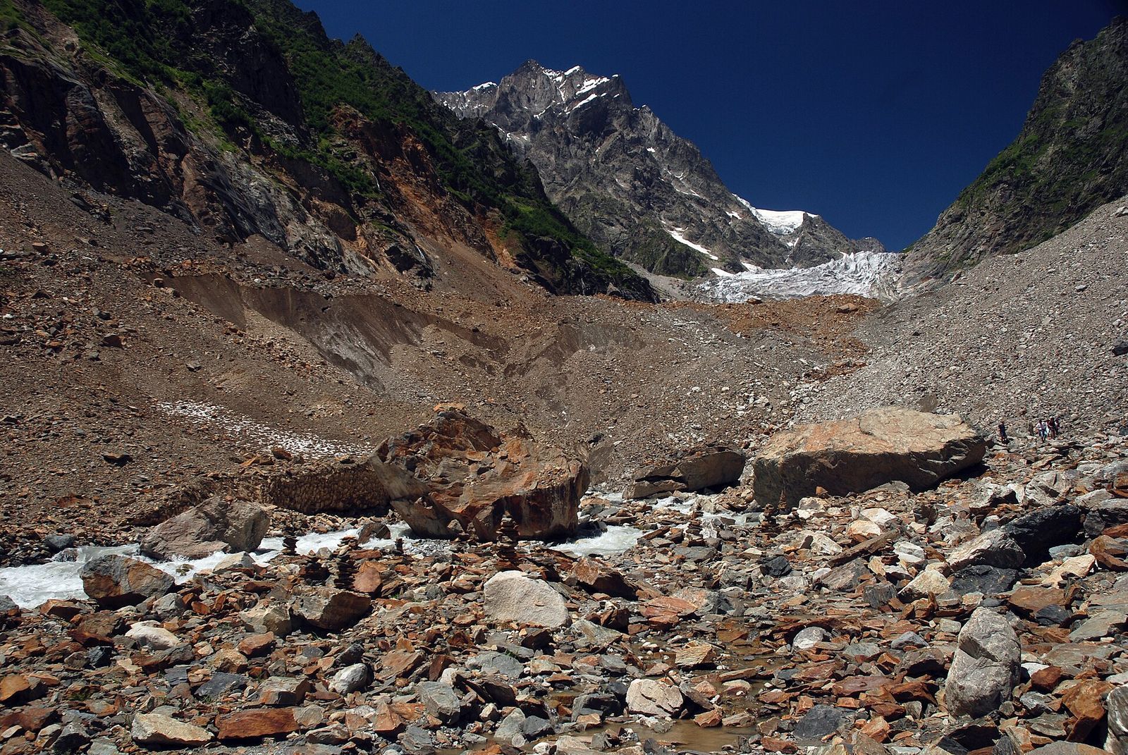The Chalaadi Glacier north of Mestia, a tongue of ice under rocky peaks with a wide field of moraine boulders in front