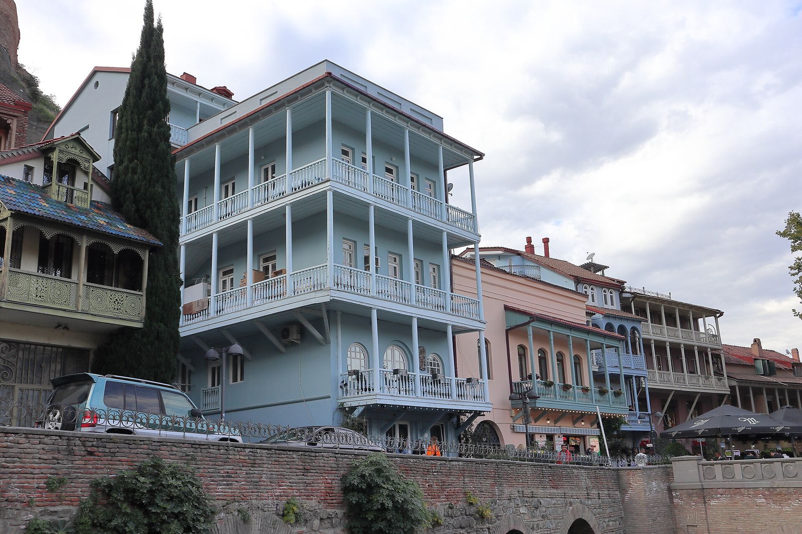 The blue house at 23 Abano Street in Abanotubani, Tbilisi, with wooden balconies on thin columns wrapping every floor