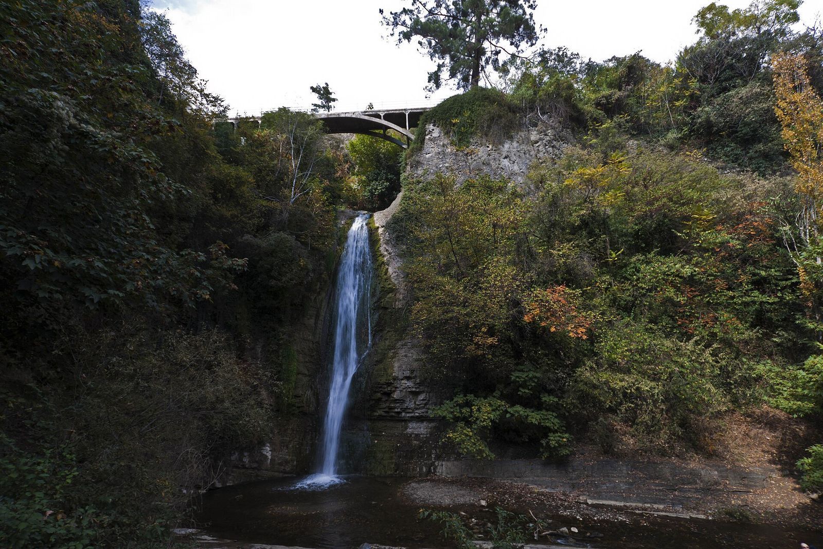 The tall waterfall in the National Botanical Garden, with a bridge over the gorge above it