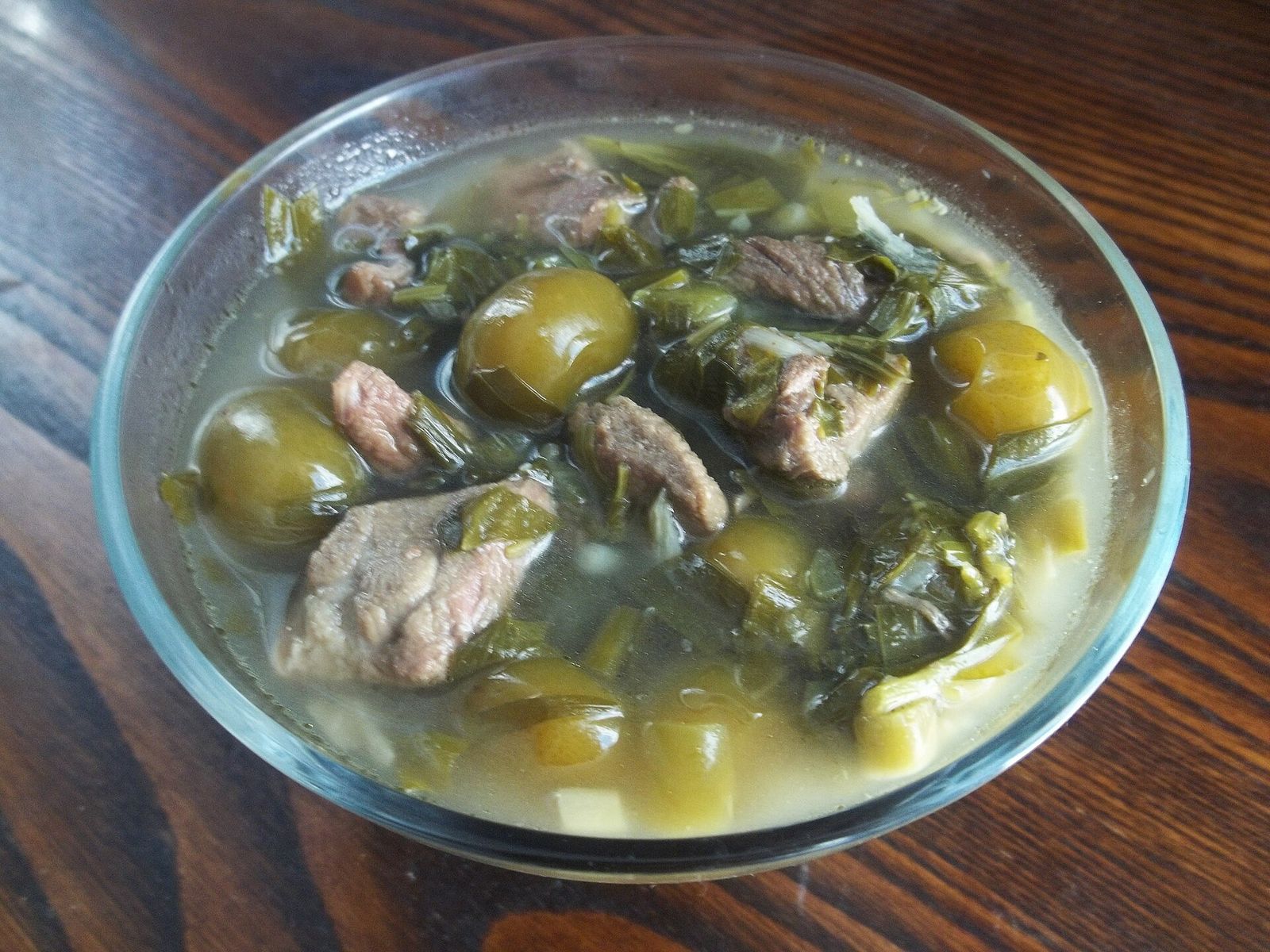 Chakapuli, a stew of meat, green sour plums and tarragon, in a glass bowl