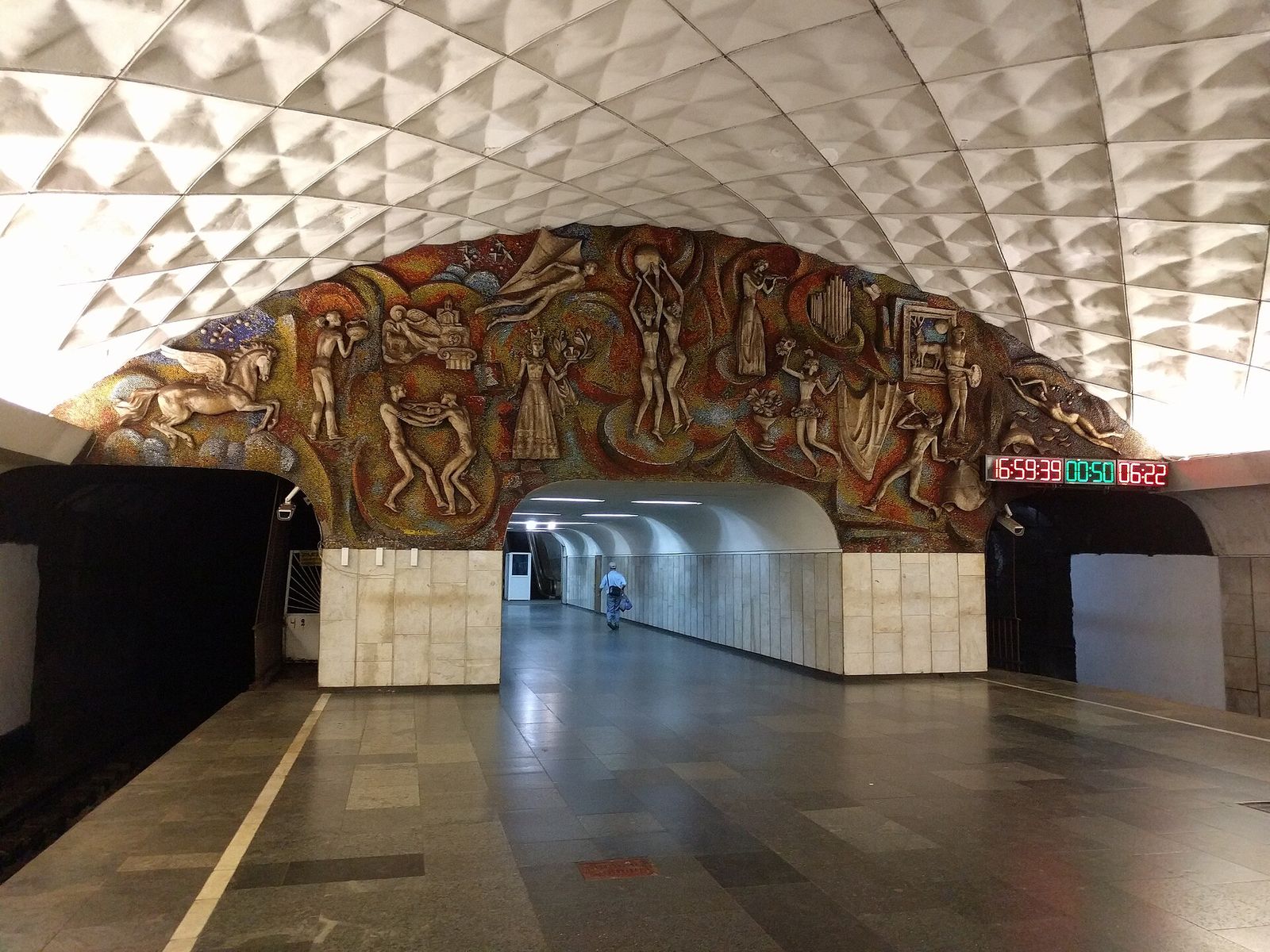A large Soviet-era mosaic panel of figures and animals above a passage at the end of the Technical University metro platform in Tbilisi