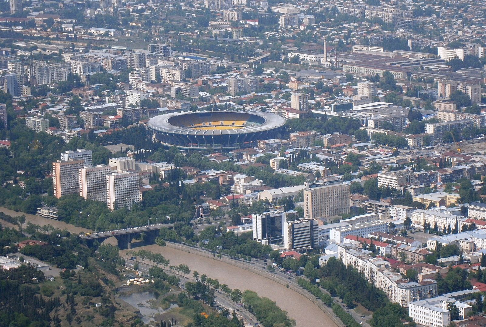 Dinamo Arena seen from the air above the Kura River in Tbilisi; Bassiani is in the old swimming pool under the stadium