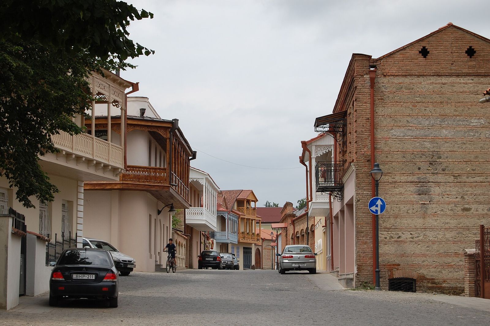 A cobbled street in Telavi's restored old town lined with two-story houses and carved wooden balconies
