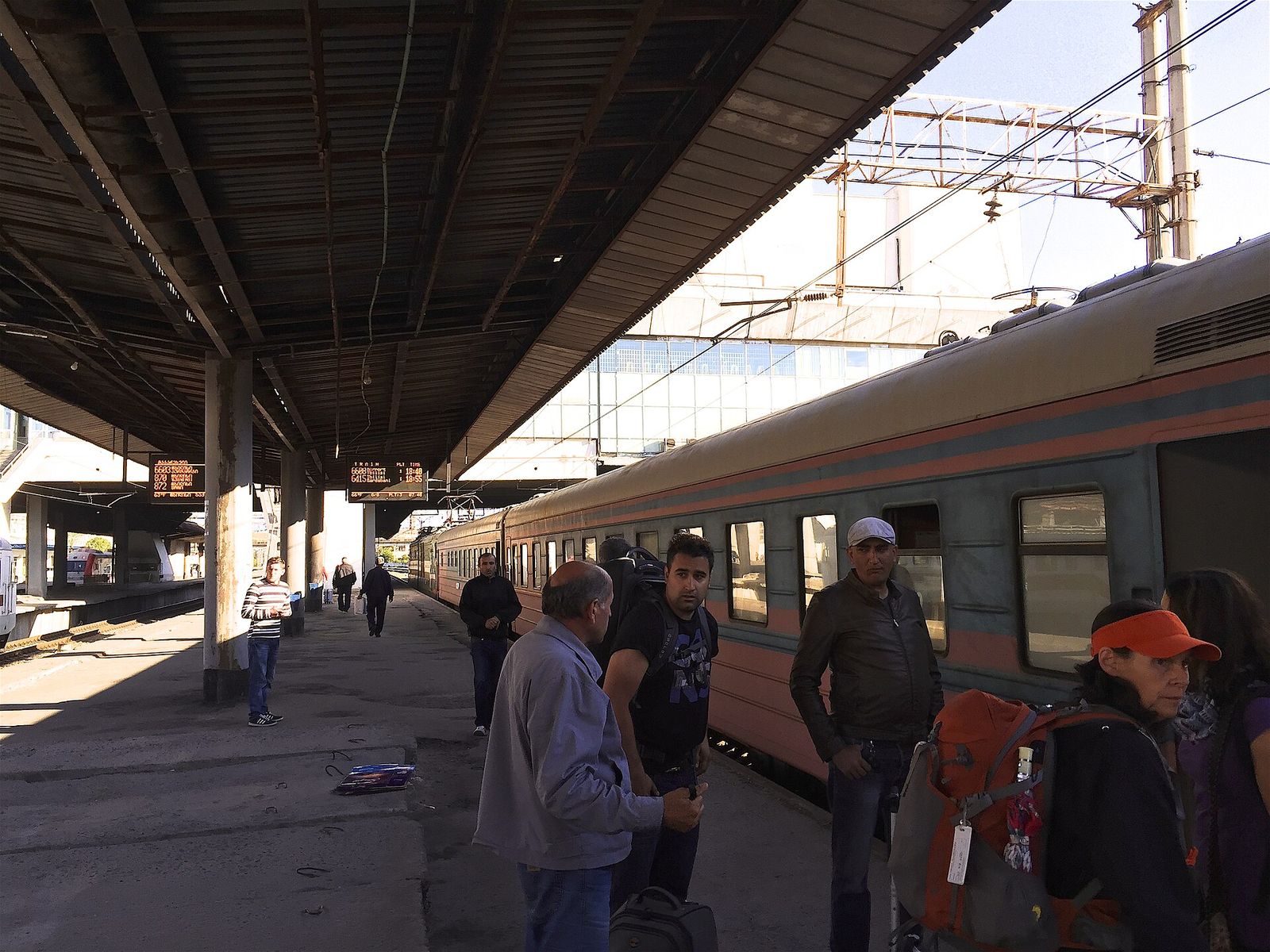 Passengers with backpacks on the platform at Tbilisi Central Station beside the overnight train from Yerevan