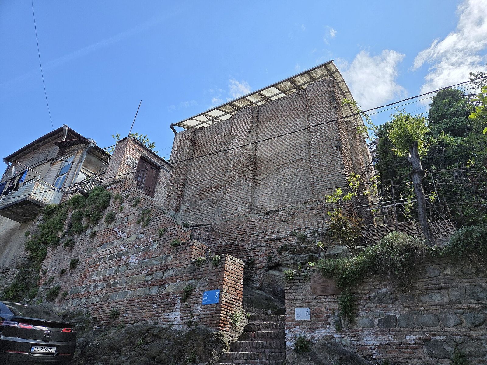 The brick walls of Atashgah, the ruined Zoroastrian fire temple on Gomi Street, with steps leading up to it