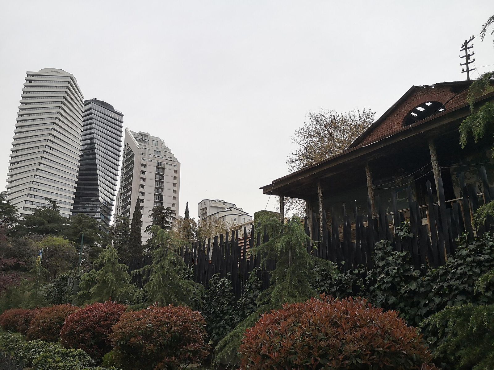 The Axis Towers on Chavchavadze Avenue in Vake, rising behind a garden and an old wooden house