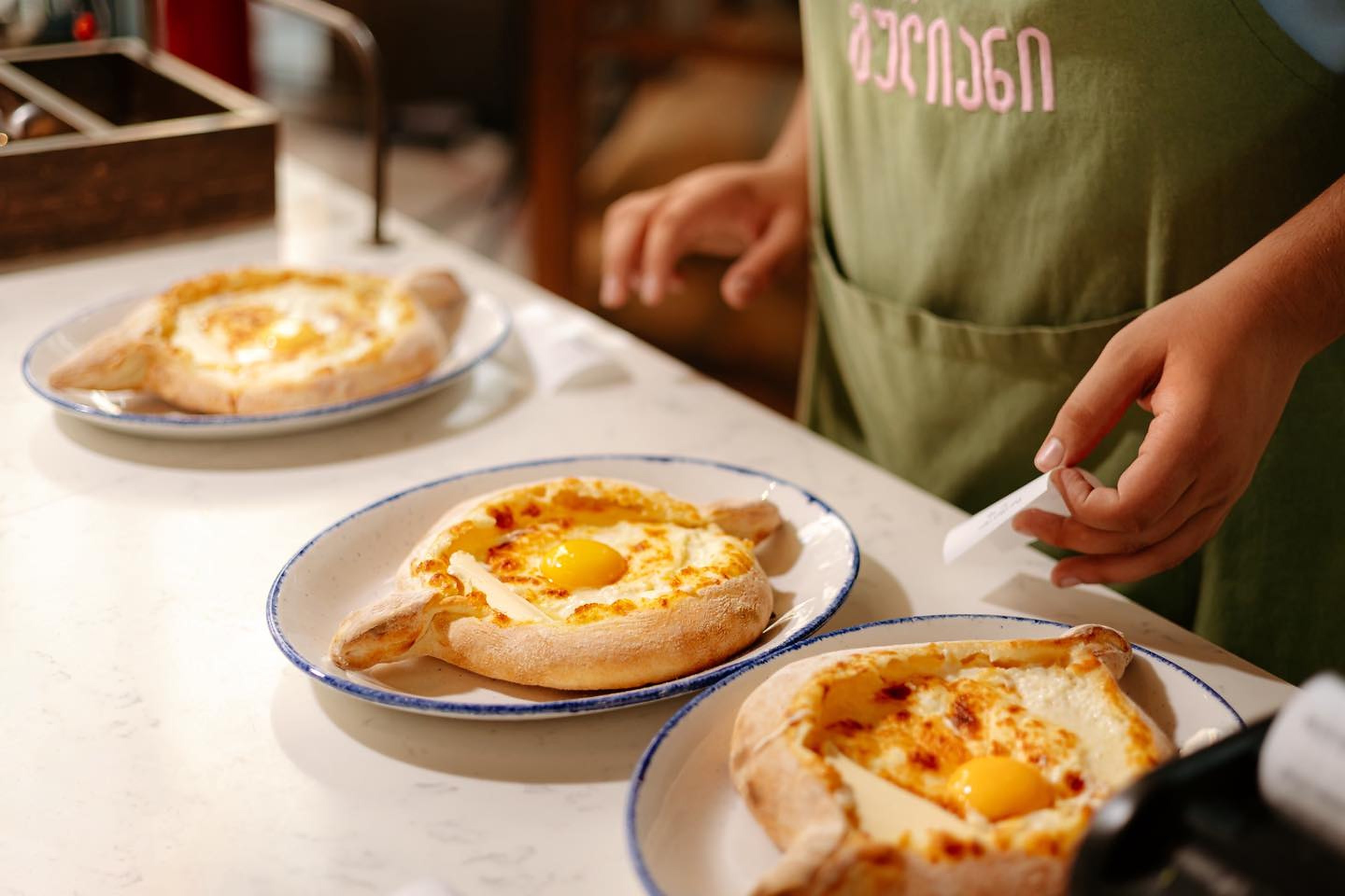 Adjarian khachapuri being served